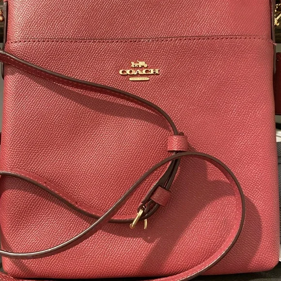 Coach cross body, mauvish pink color smaller in size like new. Only used twice. - Picture 2 of 2